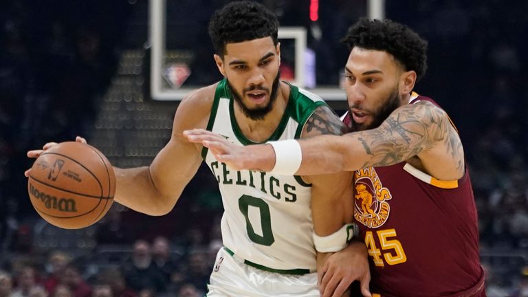 The Boston Celtics'  Jayson Tatum (0) against Cleveland Cavaliers'  Denzel Valentine, 45, in the first half of an NBA basketball game, Monday, November 15, 2021, in Cleveland.