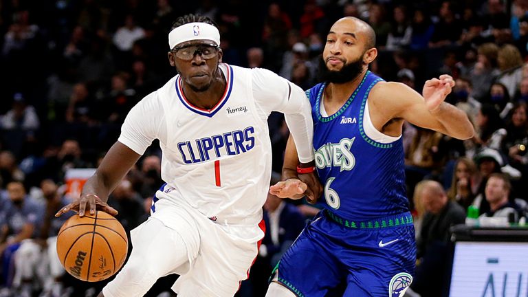 Los Angeles Clippers guard Reggie Jackson (1) drives on Minnesota Timberwolves guard Jordan McLaughlin (6) during the first half of an NBA basketball game Friday, Nov. 5, 2021, in Minneapolis. 