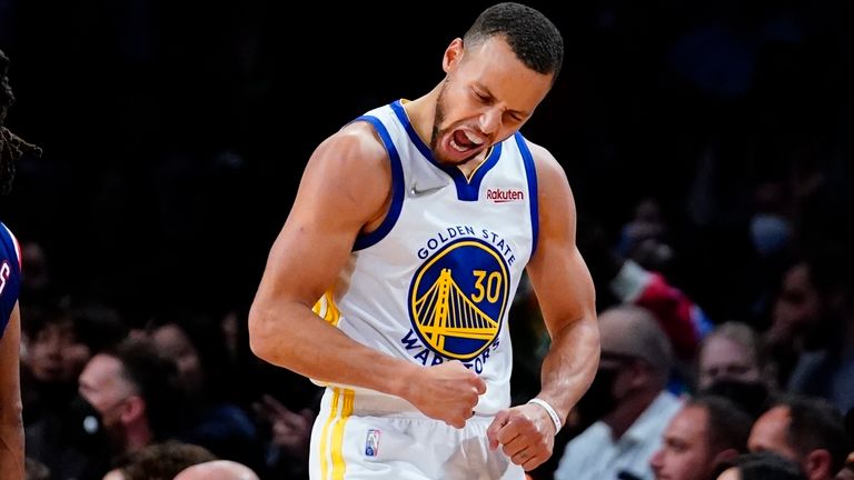 Golden State Warriors'  Stephen Curry (30) celebrates as Brooklyn Nets'  Patty Mills (8) walks away during the second half of an NBA basketball game Tuesday, Nov.  16, 2021 in New York.  The Warriors won 117-99. 
