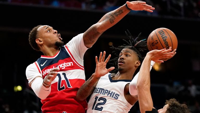 Washington Wizards center Daniel Gafford (21) attempts to block a shot attempt by Memphis Grizzlies guard Ja Morant in the first half of an NBA basketball game, Friday, Nov. 5, 2021, in Washington. 