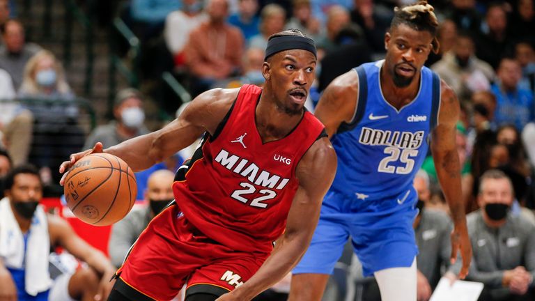 Miami Heat forward Jimmy Butler (22) dribbles the ball as Dallas Mavericks&#39; Reggie Bullock defends during the second half of an NBA basketball game Tuesday, Nov. 2, 2021, in Dallas. Miami won 125-110.