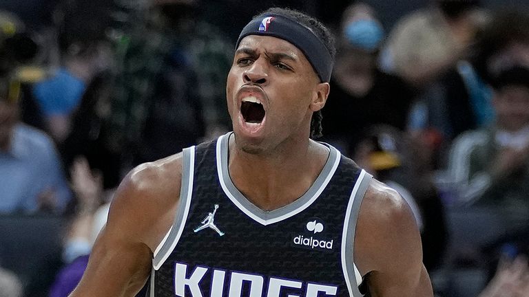 Buddy Hield #24 of the Sacramento Kings celebrates after teammate Davion Mitchell #15 made a three-point shot against the Charlotte Hornets during the fourth quarter at Golden 1 Center on November 05, 2021 in Sacramento, California.