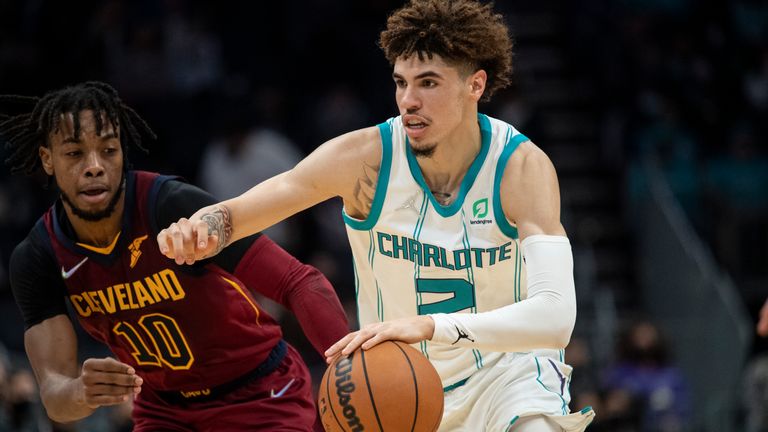 Charlotte Hornets guard LaMelo Ball (2) drives past Cleveland Cavaliers guard Darius Garland (10) during the first half of an NBA basketball game, Monday, Nov. 1, 2021, in Charlotte, N.C.