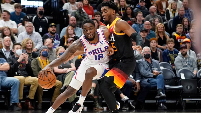 Utah Jazz guard Donovan Mitchell, right, defends against Philadelphia 76ers guard Shake Milton (18) in the first half during an NBA basketball game Tuesday, Nov. 16, 2021, in Salt Lake City.
