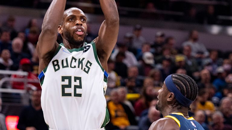Khris Middleton shoots over Indiana Pacers guard Caris LeVert