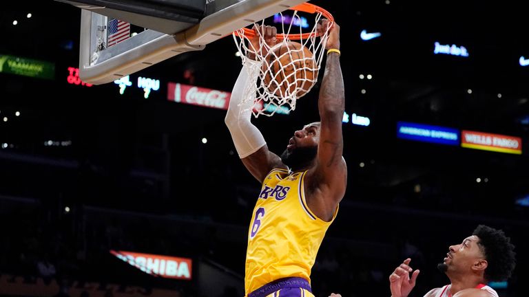 Los Angeles Lakers forward LeBron James (6) dunks past Houston Rockets center Christian Wood (35) during the first half of an NBA basketball game Tuesday, Nov. 2, 2021, in Los Angeles.