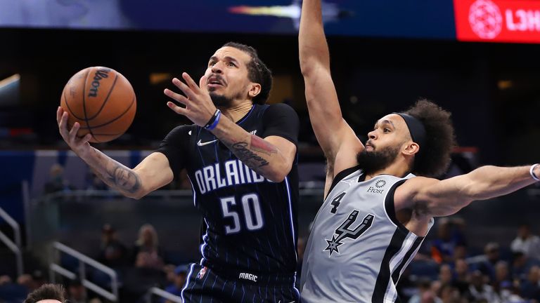 Orlando Magic guard Cole Anthony shoots in front of San Antonio Spurs guard Derrick White during the second half of an NBA basketball game Friday, Nov. 5, 2021, in Orlando, Fla. (