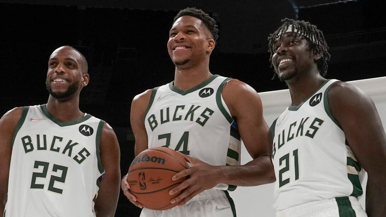 Milwaukee Bucks' Giannis Antetokounmpo is flanked by Khris Middleton and Jrue Holiday as they pose for a picture during an NBA basketball media day Monday, Sept. 27, 2021, in Milwaukee. (AP Photo/Morry Gash)