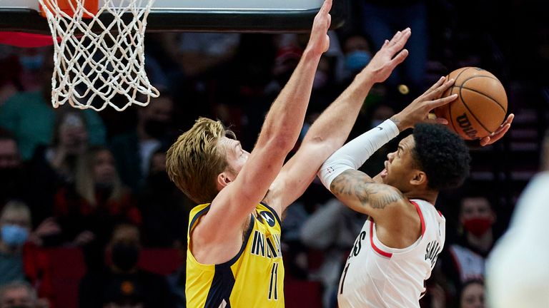 Portland Trail Blazers guard Anfernee Simons, right, shoots over Indiana Pacers forward Domantas Sabonis during the first half of an NBA basketball game in Portland, Ore., Friday, Nov. 5, 2021.