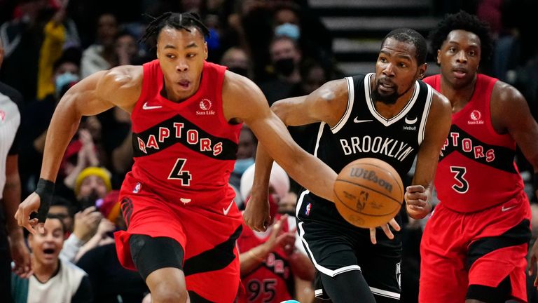 Toronto Raptors forward Scottie Barnes (4) drives upcourt after stealing the ball from Brooklyn Nets forward Kevin Durant (7) during first-half NBA basketball game action in Toronto, Sunday, Nov. 7, 2021.