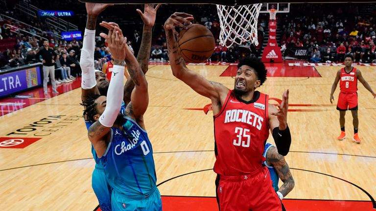 Houston Rockets center Christian Wood (35) grabs a rebound away from Charlotte Hornets forward Miles Bridges (0) during the first half of an NBA basketball game, Saturday, Nov. 27, 2021, in Houston. (AP Photo/Eric Christian Smith)


