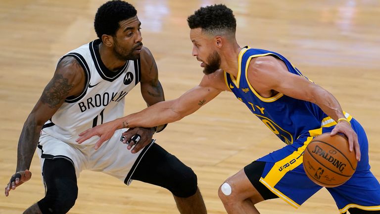 Golden State Warriors guard Stephen Curry, right, is defended by Brooklyn Nets guard Kyrie Irving during the first half of a game in February 2021