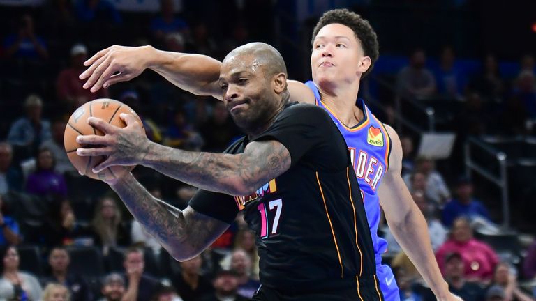 Oklahoma City Thunder center Isaiah Roby, right, tries to take the ball from Miami Heat forward P.J. Tucker (17) in the second half of an NBA basketball game, Monday, Nov. 15, 2021, in Oklahoma City. 