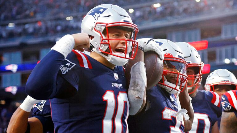 New England Patriots running back Damien Harris, right, celebrates with quarterback Mac Jones, left, after his touchdown during the second half of an NFL football game against the Tennessee Titans, Sunday, Nov. 28, 2021, in Foxborough, Mass. (AP Photo/Mary Schwalm)