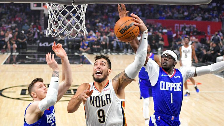 New Orleans Pelicans center Willy Hernangomez, center, shoots as Los Angeles Clippers center Isaiah Hartenstein, left, and guard Reggie Jackson defend during the first half of an NBA basketball game Monday, Nov. 29, 2021, in Los Angeles. (AP Photo/Mark J. Terrill)