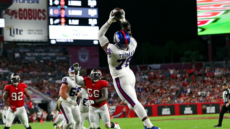 New York Giants&#39; Andrew Thomas makes the catch on a 2-yard touchdown pass from quarterback Daniel Jones during the first half of an NFL football game against the Tampa Bay Buccaneers Monday, Nov. 22, 2021, in Tampa, Fla. (AP Photo/Mark LoMoglio)
