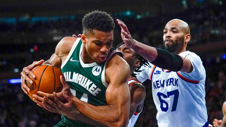 Giannis Antetokounmpo (34) protects the ball from New York Knicks&#39; Taj Gibson (67) and Immanuel Quickley during the second half of an NBA basketball game Wednesday, Nov. 10, 2021, in New York. The Bucks won 112-100. (AP Photo/Frank Franklin II)