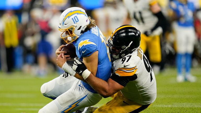 Los Angeles Chargers quarterback Justin Herbert is brought down by Pittsburgh Steelers defensive end Cameron Heyward during the second half of an NFL football game Sunday, Nov. 21, 2021, in Inglewood, Calif. 
