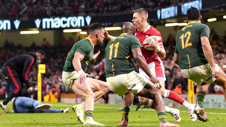 A fan invades the pitch as Wales' Liam Williams is closed down by the South Africa defence