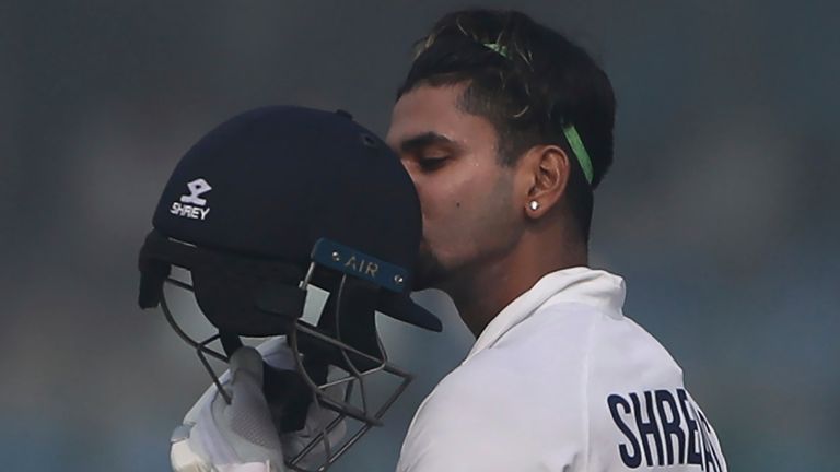 India's Shreyas Iyer kisses his helmet after scoring a century on Test debut