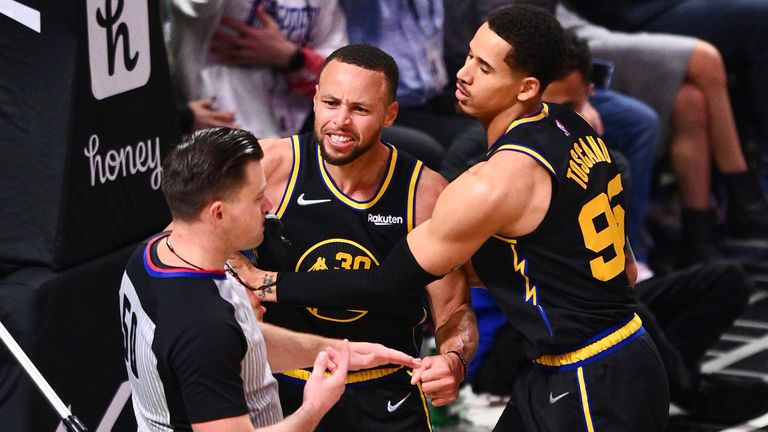 Stephen Curry is held back by Juan Toscano-Anderson as he his about to receive a technical foul during an NBA game between the Golden State Warriors and the Los Angeles Clippers