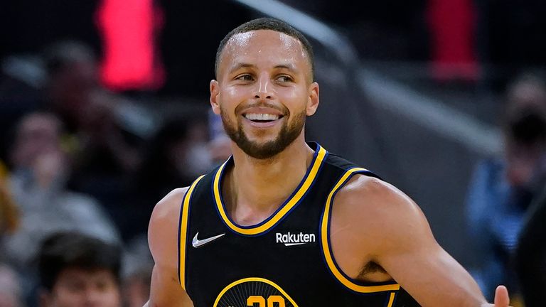 Golden State Warriors guard Stephen Curry smiles after shooting a 3-pointer against the Portland Trail Blazers 