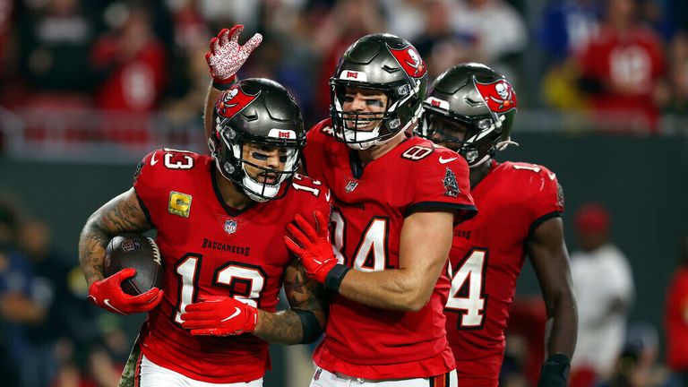 Tampa Bay Buccaneers wide receiver Mike Evans (13) celebrates his 5-yard touchdown reception with tight end Cameron Brate (84) and wide receiver Chris Godwin (14) during the second half of an NFL football game against the New York Giants Monday, Nov. 22, 2021, in Tampa, Fla. (AP Photo/Mark LoMoglio)