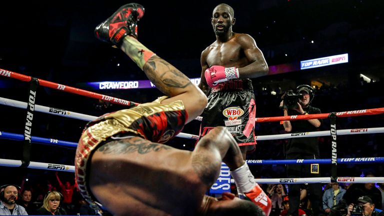 Terence Crawford stands over Jose Benavidez after he goes down in the 12th round, during their WBO world title boxing bout in Omaha, Neb., Saturday, Oct. 13, 2018. Terence Crawford won in the 12th round. (AP Photo/Nati Harnik)          
