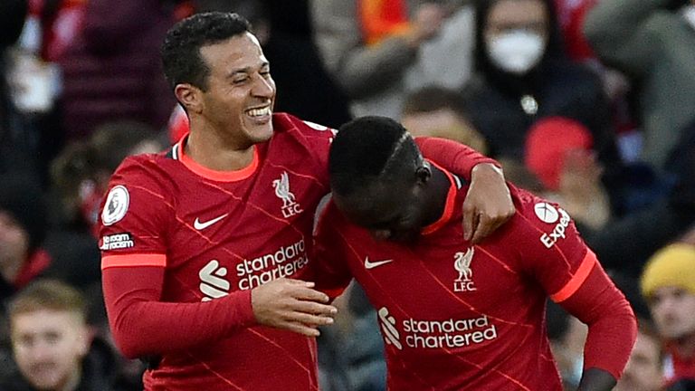 Thiago celebrates scoring Liverpool&#39;s third with Sadio Mane (AP)