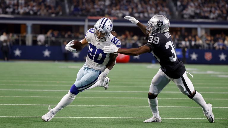 Dallas Cowboys running back Tony Pollard (20) runs the ball as Las Vegas Raiders cornerback Nate Hobbs (39) moves in to make the stop in the first half of an NFL football game in Arlington