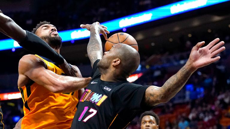 Utah Jazz center Rudy Gobert, left, goes to the basket as Miami Heat forward PJ Tucker (17) defends during the first half of an NBA basketball game, Saturday, Nov.  6, 2021, in Miami.  (AP Photo/Lynne Sladky)