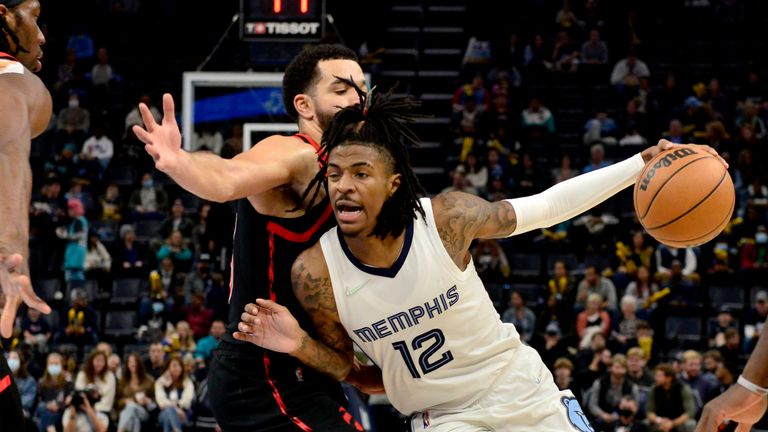 Memphis Grizzlies guard Ja Morant handles the ball against Toronto Raptors guard Fred VanVleet