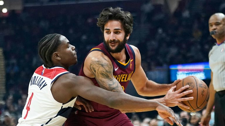 Washington Wizards&#39; Aaron Holiday (4) tries to knock the ball loose from Cleveland Cavaliers&#39; Ricky Rubio (3) in the first half of an NBA basketball game, Wednesday, Nov. 10, 2021, in Cleveland. (AP Photo/Tony Dejak)