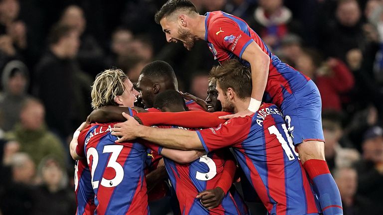 Wilfried Zaha (obscured) is mobbed by teammates after giving Palace the lead 