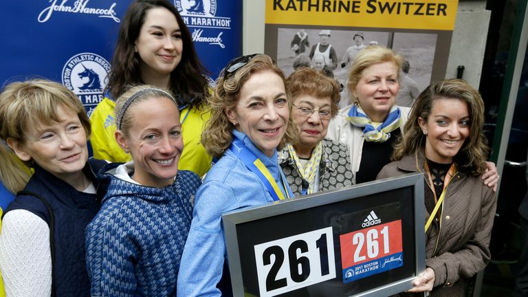 Kathrine Switzer, middle, the first official woman entrant in the Boston Marathon 50 years ago, poses with runners from her 261 Fearless foundation and BAA officials at a news conference, Tuesday, April 18, 2017, in Boston, where her Bib No. 261 was retired in her honor by the Boston Athletic Association