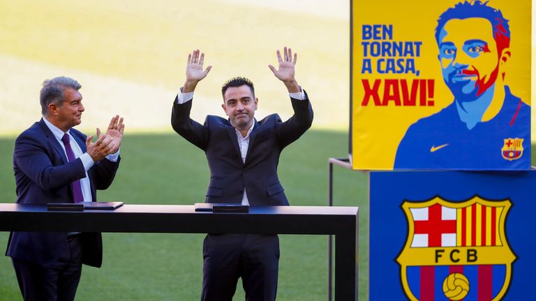 Xavi soaks up the applause with Barcelona president Joan Laporta joining in