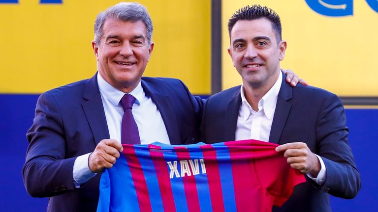 Joan Laporta presents Xavi with a Barcelona shirt at his unveiling 