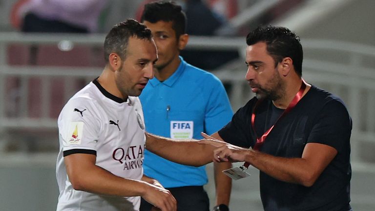 Sadd's coach Xavi Hernandez (R) speaks to midfielder Santi Cazorla during the Qatar Cup semi-final football match between Al-Rayyan and Al-Sadd at the Abdullah bin Khalifa Stadium in the capital Doha on February 18, 2021