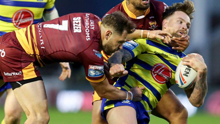 Picture by Paul Currie/SWpix.com - 17/05/2021 - Rugby League - Betfred Super League Round 6 - Warrington Wolves v Huddersfield Giants - Halliwell Jones Stadium, Warrington, England - Warrington Wolves' Blake Austin is tackled by Huddersfield Giants' Lee Gaskell and Kenny Edwards
