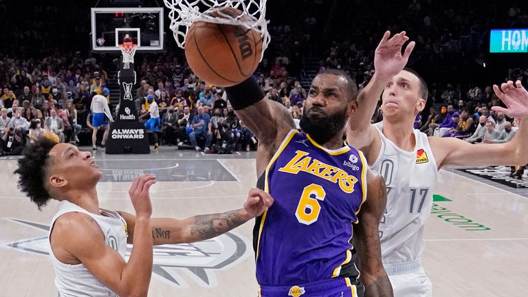 Los Angeles Lakers forward LeBron James dunks between Oklahoma City Thunder guard Tre Mann and forward Aleksej Pokusevski