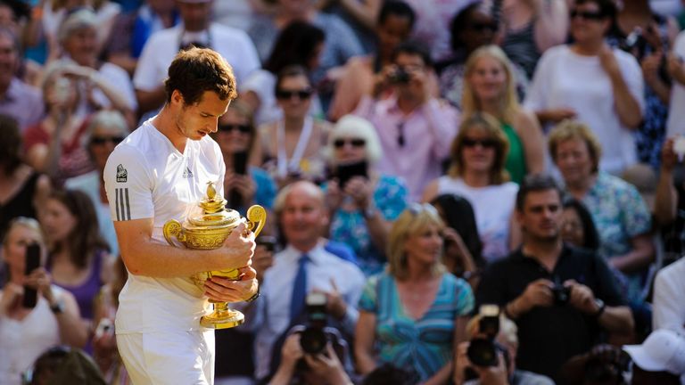 Great Britain's Andy Murray celebrates with his trophy after defeating Serbia's Novak Djokovic during day thirteen of the Wimbledon Championships at The All England Lawn Tennis and Croquet Club, Wimbledon.