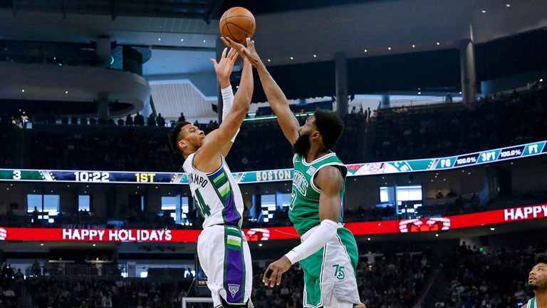 Milwaukee Bucks forward Giannis Antetokounmpo shoots over Boston Celtics guard Jaylen Brown
