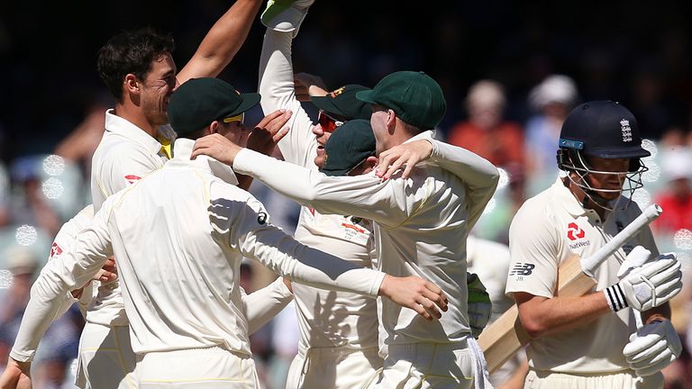 Australian teammates celebrate as England's Jonny Bairstow, right, walks away at the end of their Ashes cricket test match in Adelaide, Wednesday, Dec. 6, 2017. Australia won by 120 runs. (AP Photo/Rick Rycroft)..