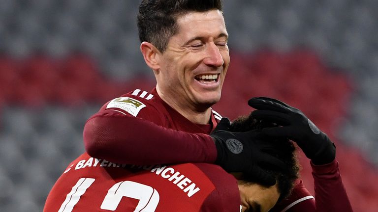 Robert Lewandowski celebrates with Jamal Musiala after scoring Bayern Munich&#39;s fourth goal