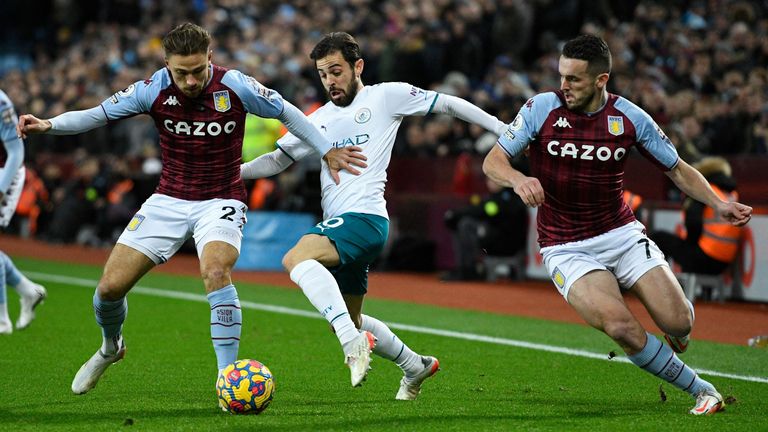 Bernardo Silva (C) vies with Matty Cash (L) and John McGinn