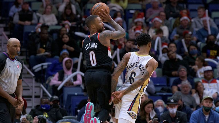 Portland Trail Blazers guard Damian Lillard (0) shoots over New Orleans Pelicans guard Nickeil Alexander-Walker (6) during the second half of an NBA basketball game in New Orleans, Tuesday, Dec. 21, 2021. (AP Photo/Matthew Hinton)



