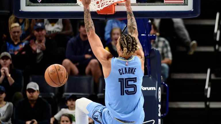 Brandon Clarke hangs on the basket following a dunk for the Memphis Grizzlies 