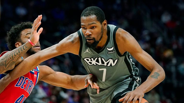Brooklyn Nets forward Kevin Durant (7) is defended by Detroit Pistons forward Saddiq Bey (41) during the second half of an NBA basketball game, Sunday, Dec. 12, 2021, in Detroit. (AP Photo/Carlos Osorio)