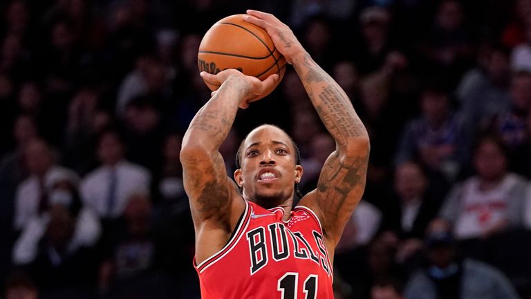 Chicago Bulls forward DeMar DeRozan shoots a three-point basket past New York Knicks guard Evan Fournier