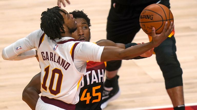 Cleveland Cavaliers guard Darius Garland goes to the basket as Utah Jazz guard Donovan Mitchell defends